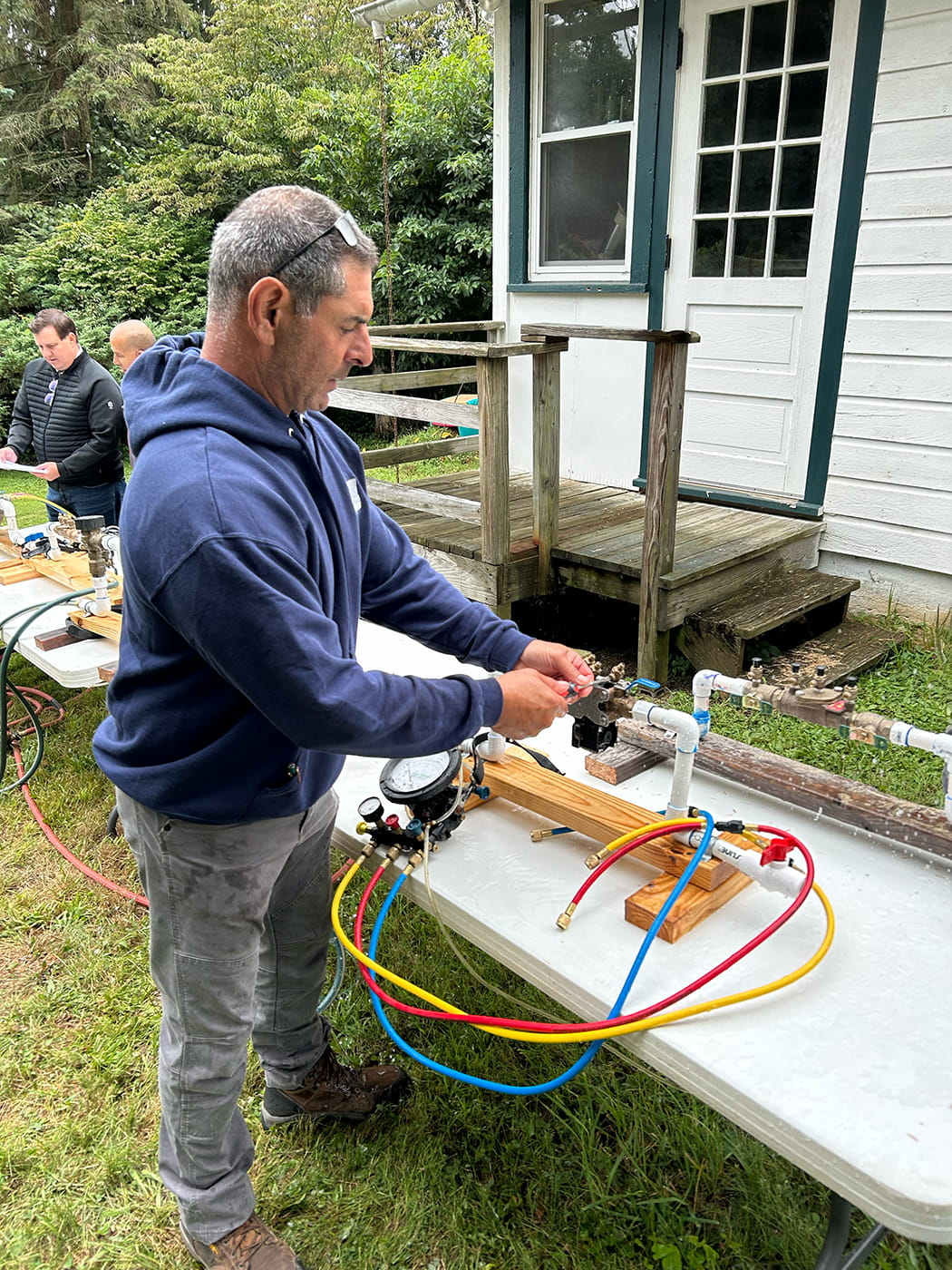 Student learning backflow prevention tester certification during backflow training for licensed plumbers and contractors